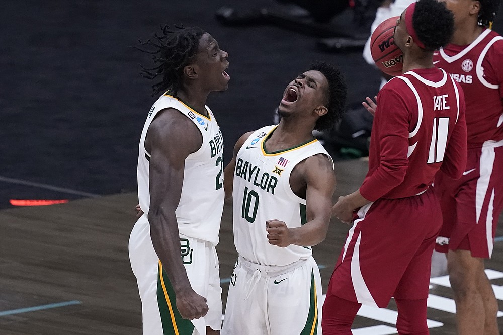 Baylor forward Jonathan Tchamwa Tchatchoua, celebrates with teammate guard Adam Flagler (10) during the second half of an Elite 8 game against Arkansas in the NCAA men's college basketball tournament at Lucas Oil Stadium, Monday, March 29, 2021, in Indianapolis. (AP Photo/Darron Cummings)