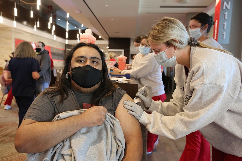 Alan Montoya, a sophomore at the University of Arkansas, receives a covid-19 vaccination shot from Kristin Smith, a J2 student in the Eleanor Mann School of Nursing at the University of Arkansas, Thursday, April 1, 2021, during an open covid-19 vaccination clinic hosted by the Northwest Arkansas Council in collaboration with the region's health care systems at Donald W. Reynolds Razorback Stadium on campus in Fayetteville. Check out nwaonline.com/210403Daily/ and nwadg.com/photos for a photo gallery.
(NWA Democrat-Gazette/David Gottschalk)