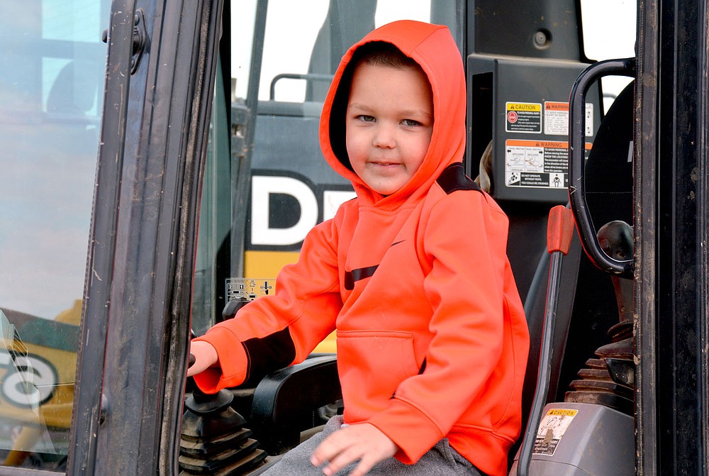 Marc Hayot/Herald-Leader Hank Griffin is ready to start digging in a Kubota dozer the city provided for kids to come touch and play in the massive vehicles.