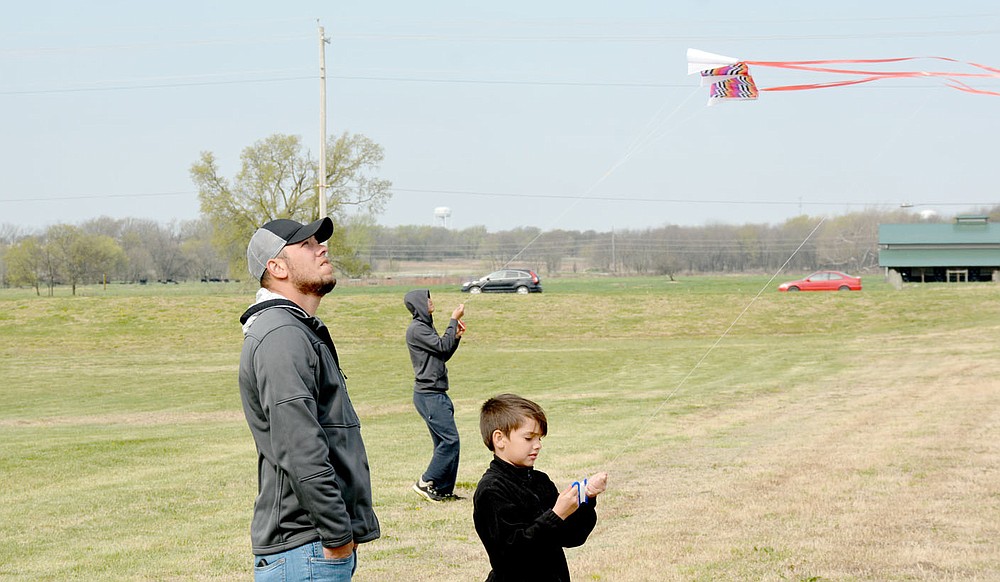 Marc Hayot/Herald-Leader Malachi Matlow (right) came out during kite day to fly his kite high as Michael Meadows looks on.