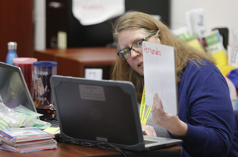 Mary Kate Wimberly, a tutor with the Migrant Education Program, works Wednesday, February 24, 2021, with on letters and the spelling of the last name of a kindergarten student through a video platform from her room at Monitor Elementary School in Springdale. Check out nwadg.com/photos for a photo gallery.
(NWA Democrat-Gazette/David Gottschalk)