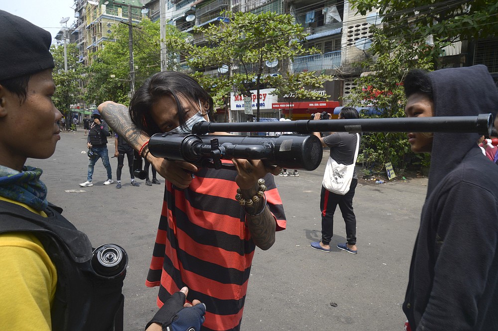 Anti-coup protesters aim with homemade air rifle during a protest in Yangon, Myanmar, Saturday, April 3, 2021. Threats of lethal violence and arrests of protesters have failed to suppress daily demonstrations across Myanmar demanding the military step down and reinstate the democratically elected government. (AP Photo)