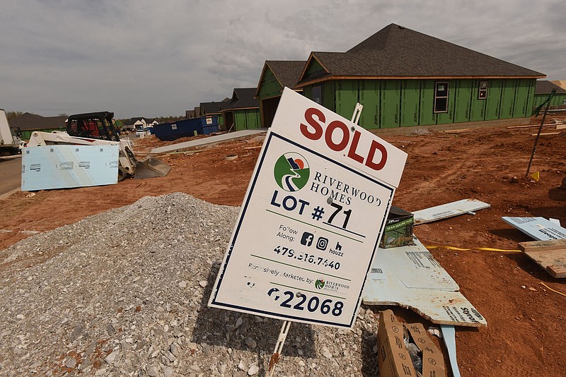 Sold signs dot the landscape on Tuesday March 30 2021 where Riverwood Homes is building a housing addition in Lowell.
(NWA Democrat-Gazette/Flip Putthoff)