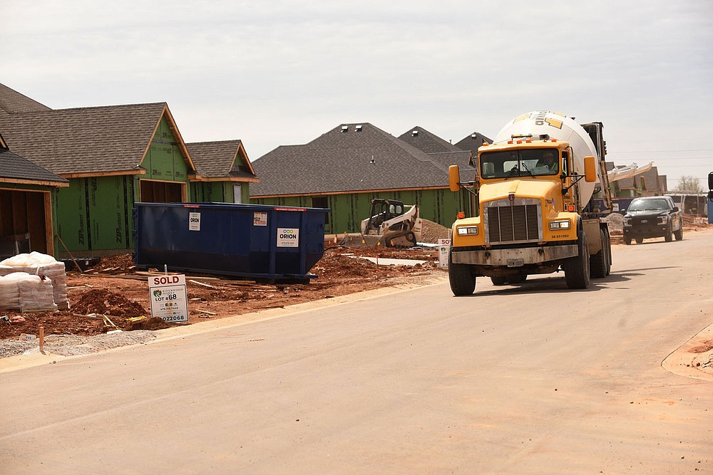 Construction traffic rolls March 30 2021 through Park View subdision in Lowell, being built by Riverwood Homes. (NWA Democrat-Gazette/Flip Putthoff)