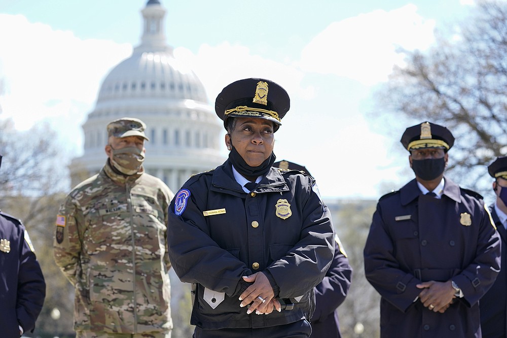 Acting chief of the U.S. Capitol Police Yogananda Pittman listens during a news conference after a car crashed into a barrier on Capitol Hill near the Senate side of the U.S. Capitol in Washington, Friday, April 2, 2021.(AP Photo/Alex Brandon)