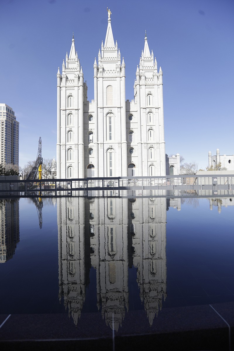 FILE - In this April 4, 2020 file photo, the Salt Lake Temple at Temple Square is shown during The Church of Jesus Christ of Latter-day Saints' twice-annual church conference  in Salt Lake City.  For the third consecutive time, The Church of Jesus Christ of Latter-day Saints will hold its signature conference this weekend without attendees in person as the faith continues to take precautions amid the pandemic.  Members of the Utah-based faith will instead watch on TVs, computers and tablets from their homes around the world Saturday, April 3, 2021 to hear spiritual guidance from the religion's top leaders, who will be delivering the speeches in Salt Lake City.  (AP Photo/Rick Bowmer)