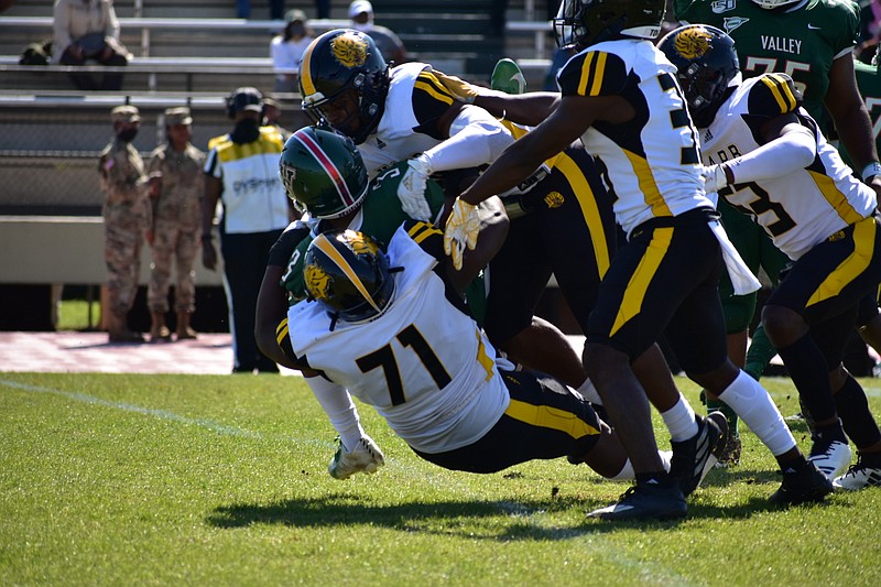 Zion Farmer (71) and other UAPB defensive players tackle Mississippi Valley State running back Caleb Johnson (3) for a loss during the first quarter Saturday, April 3, 2021, at Rice-Totten Stadium in Itta Bena, Miss. (Pine Bluff Commercial/I.C. Murrell)