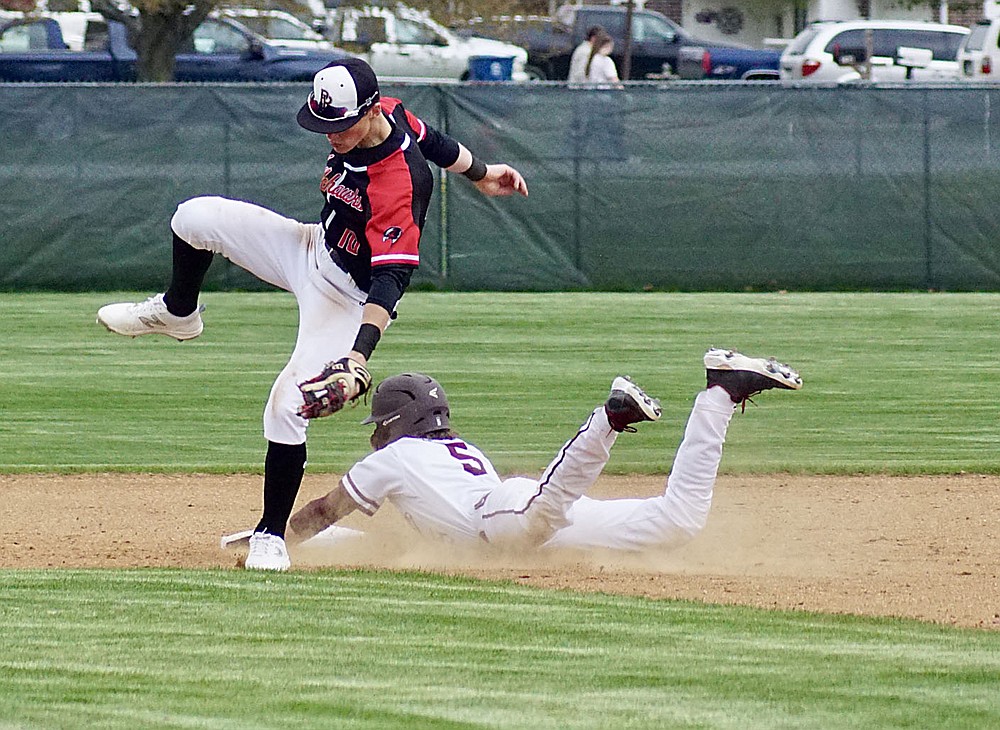 Westside Eagle Observer/RANDY MOLL
Gentry's Garry Cox slides into second and almost takes down the Pea Ridge second baseman in the play on March 30 at Gentry High School. The throw missed it mark and was stopped by the centerfielder, allowing Cox to advance.