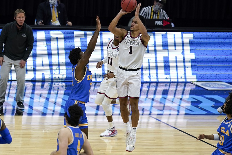 Gonzaga guard Jalen Suggs (1) shoots over UCLA guard David Singleton (34) to win the game during overtime in Saturday's men's Final Four NCAA basketball tournament semifinal game at Lucas Oil Stadium in Indianapolis. Gonzaga won 93-90. - Photo by Michael Conroy of The Associated Press
