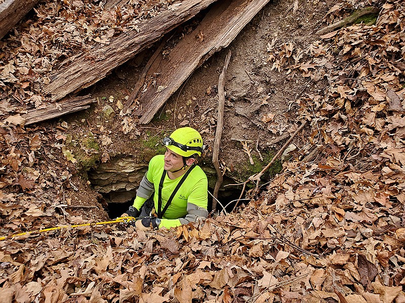 Aaron Thompson, Cave Research Foundation volunteer, uses descending gear to explore a newly discovered pit entrance at Slippery Hollow Natural Area in 2020.  (Special to the Arkansas Democrat-Gazette)