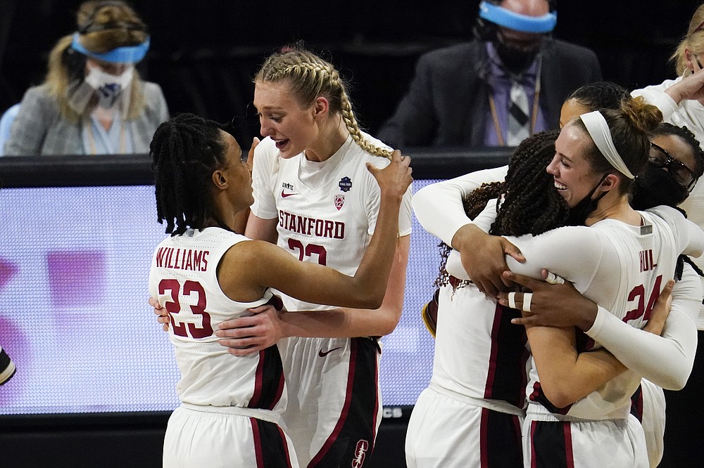 Stanford guard Kiana Williams (23) celebrates with teammate forward Cameron Brink at the end of the championship game against Arizona in the women's Final Four NCAA college basketball tournament, Sunday, April 4, 2021, at the Alamodome in San Antonio. Stanford won 54-53. (AP Photo/Eric Gay)