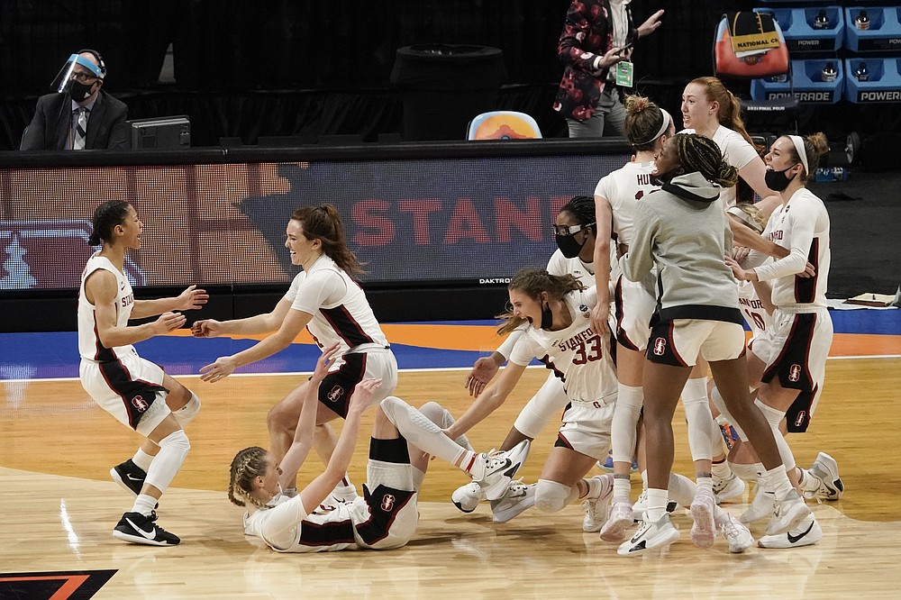 Stanford players celebrate at the end of the championship game against Arizona in the women's Final Four NCAA college basketball tournament, Sunday, April 4, 2021, at the Alamodome in San Antonio. Stanford won 54-53. (AP Photo/Morry Gash)