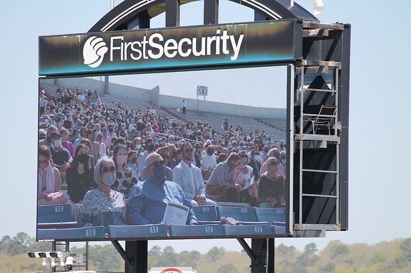 Masked congregants are shown on this screen watching the "Easter With Pulaski Heights" service at War Memorial Stadium in Little Rock on Sunday, April 4, 2021. Organized by nearby Pulaski Heights United Methodist Church, the communitywide event was a way for the church to hold a larger gathering with social distancing and other protocols in place to prevent the spread of covid-19.
Arkansas Democrat-Gazette/Francisca Jones