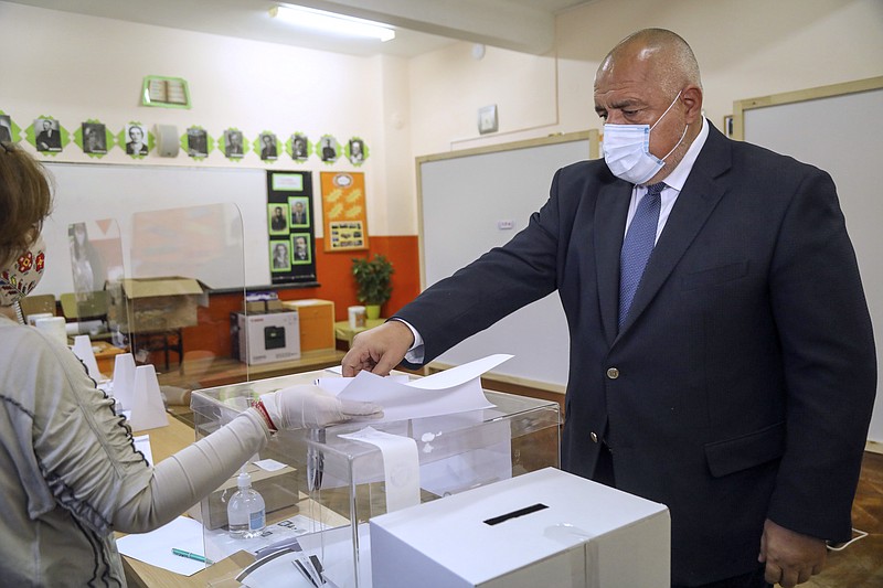 In this photo released by the GERZB Party, Bulgarian Prime Minister Boyko Borissov casts his ballot during parliamentary elections in the town of during the parliamentary elections in the town of Bankya, Bulgaria, Sunday, April 4. Bulgarians are heading to the polls on Sunday to cast ballots for a new parliament after months of anti-government protests and amid a surge of coronavirus infections. - GERB Party  via AP