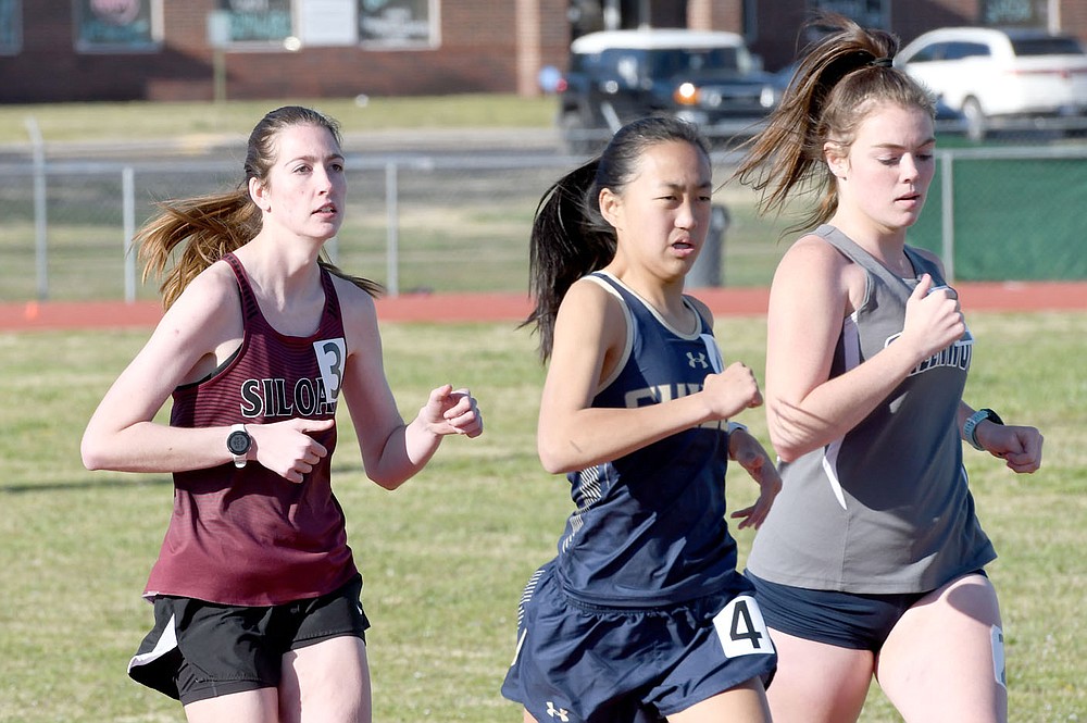 Bud Sullins/Special to the Herald-Leader
Shayla Conley, left, runs in the 1,600-meter run in the Panther Relays at Glenn W. Black Stadium.