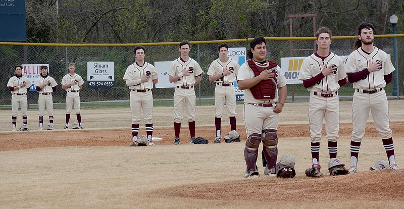 Graham Thomas/Herald-Leader
The Siloam Springs baseball team's starting lineup stands at attention for the national anthem prior to its games against Alma on March 30.
