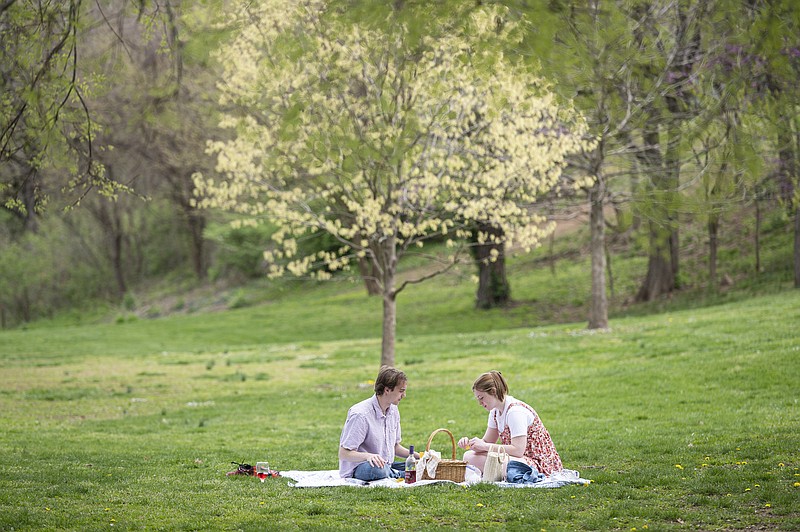 Dominick Bruno and Scarlett Turner enjoy some charcuterie and the beautiful weather Monday in the Wilson Park in Fayetteville. There is some chance of rain on Wednesday and tempters are expected to stay in the lower to mid 70s for the rest of the week. 
 (NWA Democrat-Gazette/Spencer Tirey)