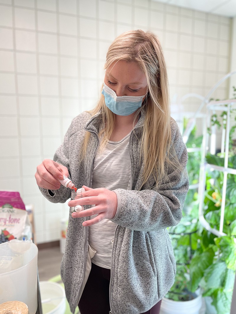 Sophie Weaver, a junior at White Hall High School, says she enjoys caring for the fish and watching the plants grow from seed to harvested produce. (Special to The Commercial)