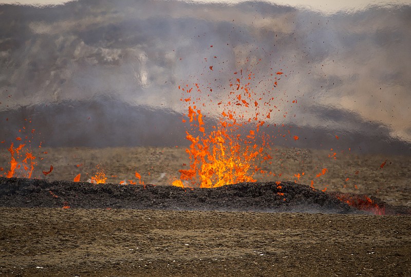 Steam and lava spurt from a new fissure on a volcano on the Reykjanes Peninsula in southwestern Iceland, Monday, April 5, 2021. The new fissure has opened up at the Icelandic volcano that began erupting last month, prompting the evacuation of hundreds of hikers who had come to see the spectacle. Officials say the new fissure is about 500 meters (550 yards) long and about one kilometer (around a half-mile) from the original eruption site in the Geldinga Valley (AP Photo/Marco Di Marco)