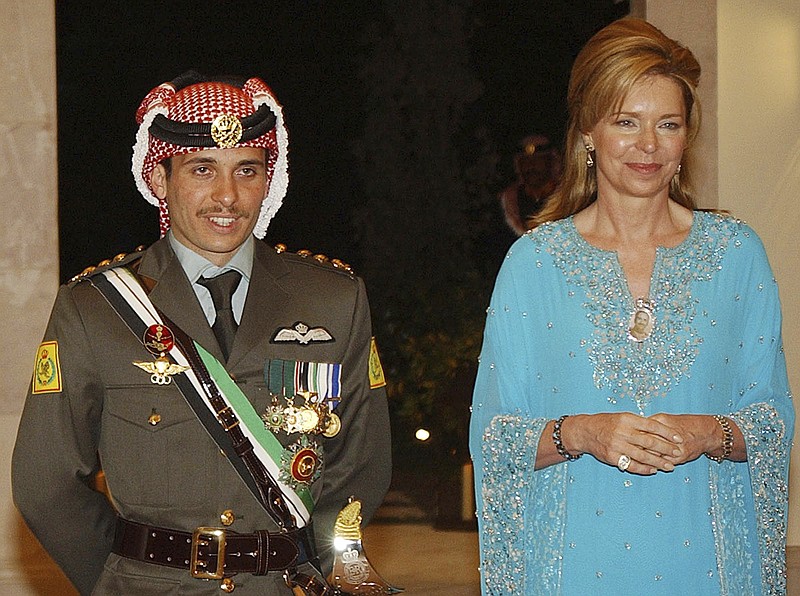 CORRECTS NAME TO PRINCE HAMZAH --  FILE - In this May 27, 2004 file photo, Jordan's Prince Hamzah left, with his mother Queen Noor, stands during his wedding ceremony in Amman, Jordan. Prince Hamzah, the half-brother of Jordan's King Abdullah II, said he has been placed under house arrest in a videotaped statement late Saturday, April 3, 2021. (AP Photo/Hussein Malla, File)