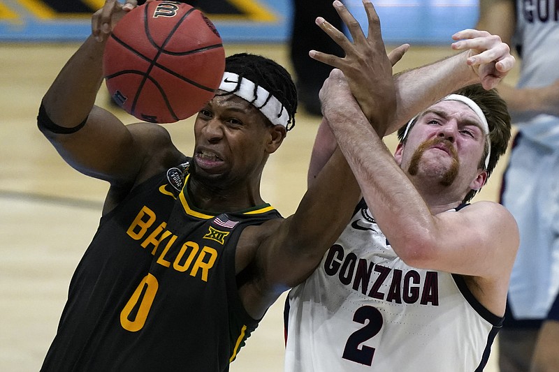 Baylor forward Flo Thamba (0) fights for a rebound with Gonzaga forward Drew Timme (2) during the first half of the championship game in the men's Final Four NCAA college basketball tournament, Monday, April 5, 2021, at Lucas Oil Stadium in Indianapolis. (AP Photo/Michael Conroy)