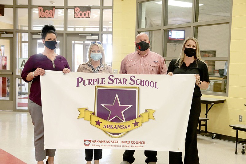 LYNN KUTTER ENTERPRISE-LEADER
Jody Bergstron, left, and Andelyn Wright, right, both with the Arkansas Council for Military Interstate Children's Compact Commission, stand with Shannon Cantrell, principal at Folsom Elementary, and Jon Purifoy, Farmington High principal. Both schools were named Purple Star Schools for their efforts in assisting children of military families.