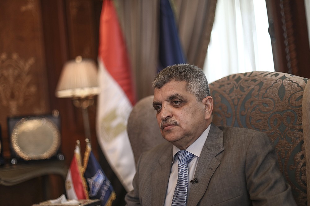 The Suez Canal chief Lt. Gen. Osama Rabie sits during an interview in Ismailia, Egypt, Tuesday, April 6, 2021. The Suez Canal chief said that authorities are negotiating a financial settlement with the owners of a massive vessel that blocked the crucial waterway for nearly a week. (AP Photo/Mohamed Elshahed)