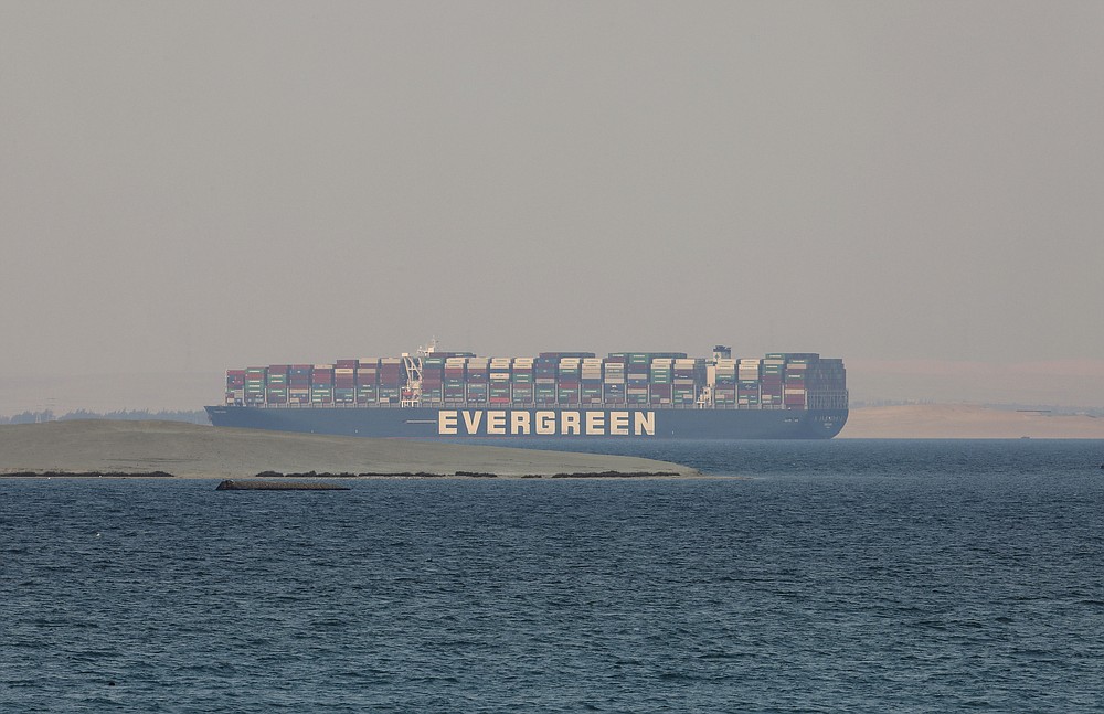 FILE - In this March 30, 2021 file photo, the Ever Given, a Panama-flagged cargo ship, is seen in Egypt's Great Bitter Lake. The Suez Canal chief said Tuesday, April 6, 2021, that authorities are negotiating a financial settlement with the owners of the massive vessel that blocked the crucial waterway for nearly a week. (AP Photo/Mohamed Elshahed, File)