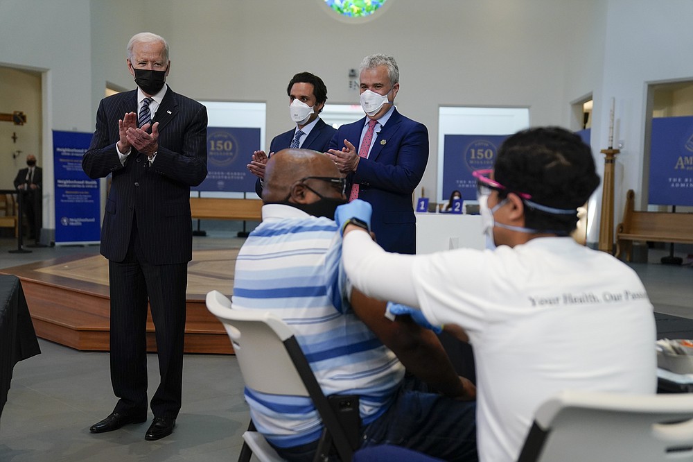 President Joe Biden applauds as a person receives a COVID-19 vaccination shot as he visits a vaccination site at Virginia Theological Seminary, Tuesday, April 6, 2021, in Alexandria, Va. (AP Photo/Evan Vucci)