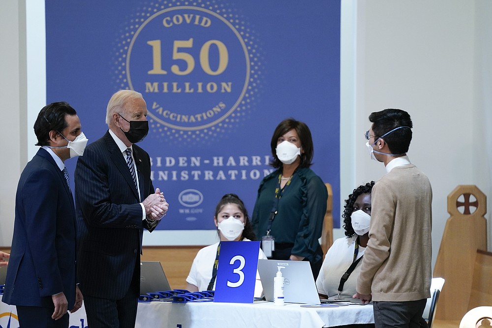 President Joe Biden speaks with health care workers as he visits a vaccination site at Virginia Theological Seminary, Tuesday, April 6, 2021, in Alexandria, Va. (AP Photo/Evan Vucci)