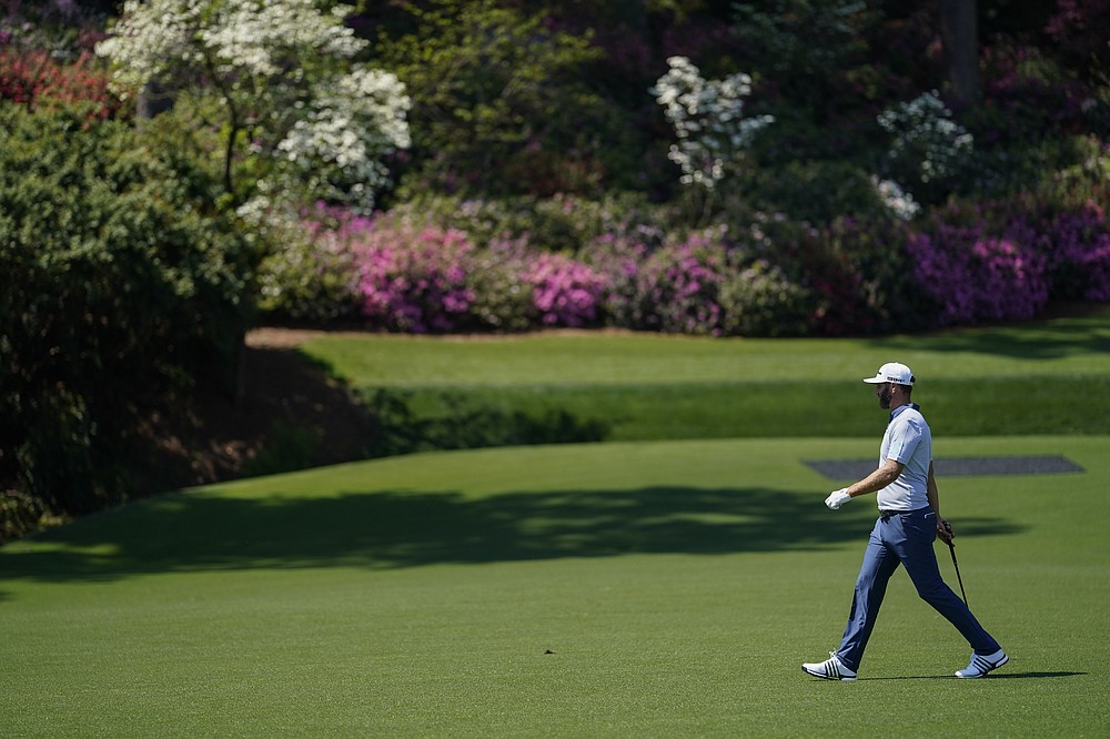 Dustin Johnson walks to the 13th green during a practice round for the Masters golf tournament on Tuesday, April 6, 2021, in Augusta, Ga. (AP Photo/David J. Phillip)