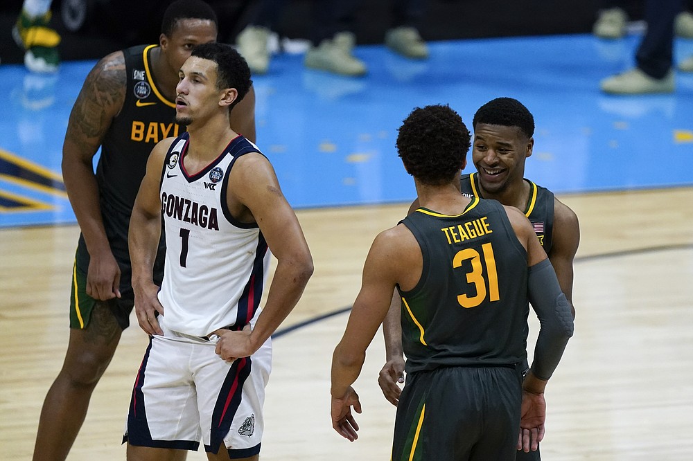 Baylor guard Jared Butler, right, celebrates with teammate guard MaCio Teague (31) in front of Gonzaga guard Jalen Suggs (1) at the end of the championship game in the men's Final Four NCAA college basketball tournament, Monday, April 5, 2021, at Lucas Oil Stadium in Indianapolis. (AP Photo/Michael Conroy)
