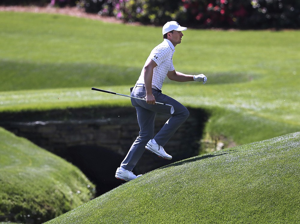 Jordan Spieth runs across the tributary to Rae's Creek to the 13th green during his practice round for the Masters at Augusta National Golf Club on Tuesday, April 6, 2021, in Augusta, Ga. (Curtis Compton/Atlanta Journal-Constitution via AP)