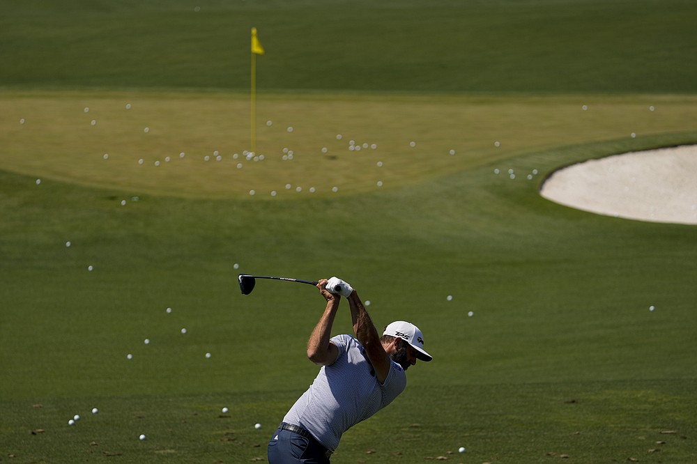 Dustin Johnson swings on the range after a practice round for the Masters golf tournament on Tuesday, April 6, 2021, in Augusta, Ga. (AP Photo/Charlie Riedel)