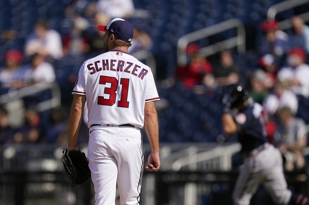 Washington Nationals starting pitcher Max Scherzer watches as Atlanta Braves' Dansby Swanson rounds the bases after hitting a solo home run in the second inning of an opening day baseball game at Nationals Park, Tuesday, April 6, 2021, in Washington. (AP Photo/Alex Brandon)