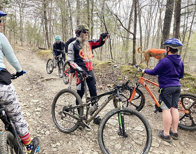 Bob Cable talks about the history of two homesteads at Devil's Den State Park while leading the Saturday morning family ride on April 3 2021 along Fossil Flats Trail. Cable has attended all 32 Ozark Mountain Bike Festivals and volunteered at most of them.
(NWA Democrat-Gazette/Flip Putthoff)