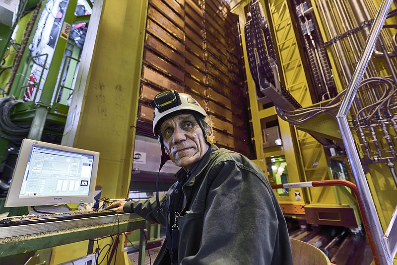 In this 2018 photo made available by CERN, Nikolai Bondar works on the LHCb Muon system at the European Organization for Nuclear Research Large Hadron Collider facility outside of Geneva. Preliminary results published in 2021 of experiments from here and the Fermilab facility in the U.S. challenge the way physicists think the universe works, a prospect that has the field of particle physics both baffled and thrilled. (Maximilien Brice, Julien Marius Ordan/CERN via AP)