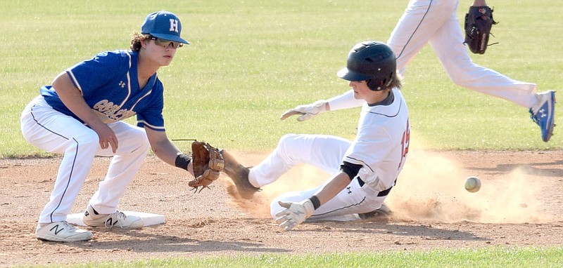 Westside Eagle Observer/MIKE ECKELS
Lion runner Keegan Bulza (19 center) slides into second base ahead of the ball during the second inning of the Gravette-Harrison conference baseball game at Lion Ballpark in Gravette Thursday night. Bulza made it to second base but the ball bounded out of the second baseman's glove.