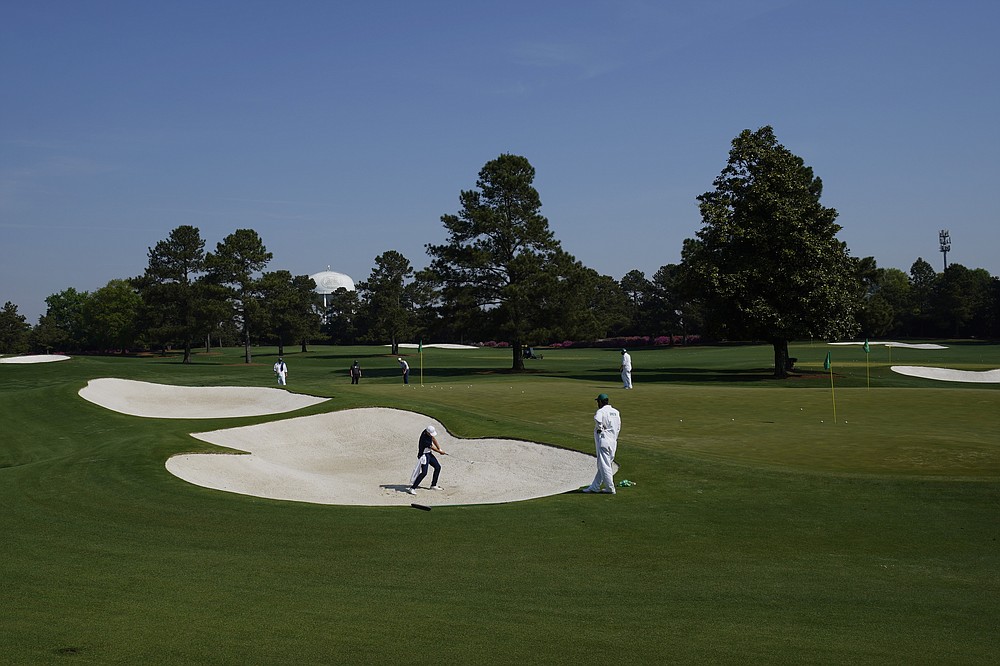 Jordan Spieth hits out of a bunker on the driving range during a practice round for the Masters golf tournament on Wednesday, April 7, 2021, in Augusta, Ga. (AP Photo/Charlie Riedel)