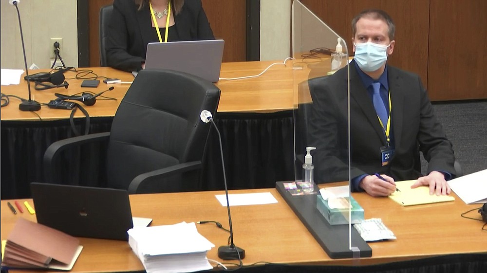 In this image taken from video, former Minneapolis police Officer Derek Chauvin watches as defense attorney Eric Nelson questions witness Los Angeles police department Sergeant Jody Stiger, Wednesday, April 7, 2021, during Chauvin's at the trial at the Hennepin County Courthouse in Minneapolis. Chauvin is charged in the May 25, 2020 death of George Floyd. (Court TV via AP, Pool)