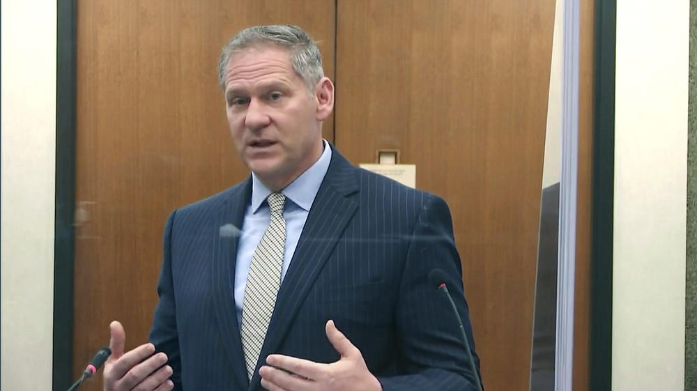 In this image from video, prosecutor Steve Schleicher questions witness Los Angeles police department Sgt. Jody Stiger, as Hennepin County Judge Peter Cahill presides Wednesday, April 7, 2021, in the trial of former Minneapolis police Officer Derek Chauvin at the Hennepin County Courthouse in Minneapolis. Chauvin is charged in the May 25, 2020 death of George Floyd. (Court TV via AP, Pool)