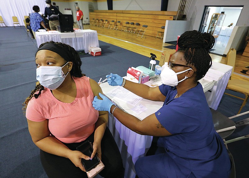 Deanna Sanders gets her covid-19 vaccine from medical assistant Makesha Tillman during the vaccine clinic on Wednesday, April 7, 2021, at Shorter College in North Little Rock. 
(Arkansas Democrat-Gazette/Thomas Metthe)