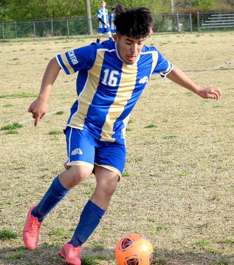 Westside Eagle Observer/MIKE ECKELS
Christian Ramirez concentrates on the ball as he moves it through traffic on his way to the Panther goal during the April 6 Decatur-Bergman conference soccer match at Bulldog Stadium in Decatur. Ramirez managed to make a run on the goal but the Panther goalie caught the ball, preventing a Bulldog score.