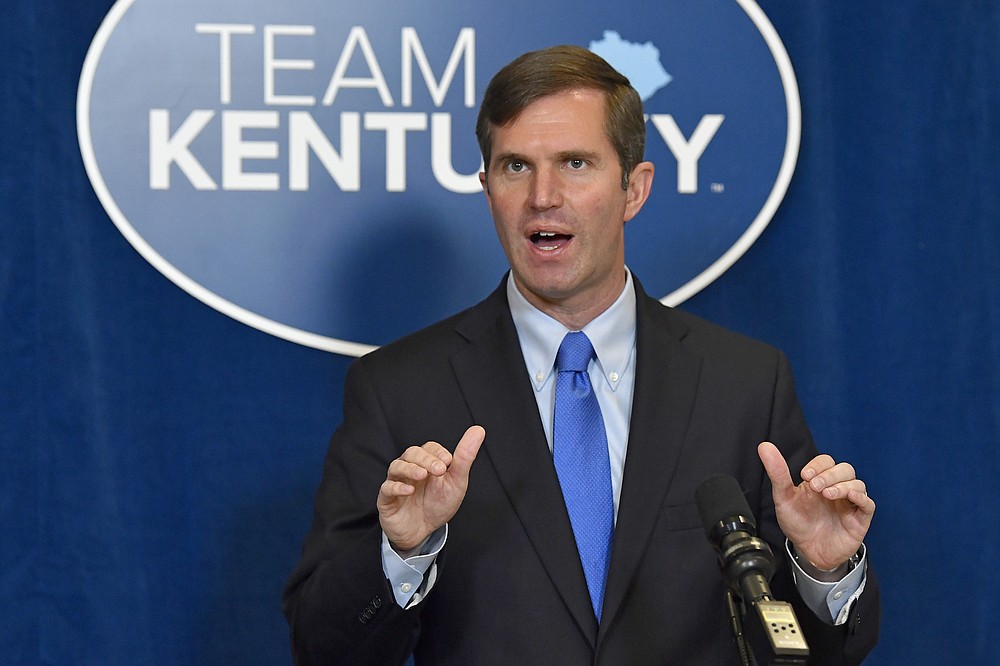Kentucky Governor Andy Beshear speaks to reporters following the signing of bills related to the American Rescue Plan Act at the Kentucky State Capitol in Frankfort, Ky., Wednesday, April 7, 2021. (AP Photo/Timothy D. Easley)