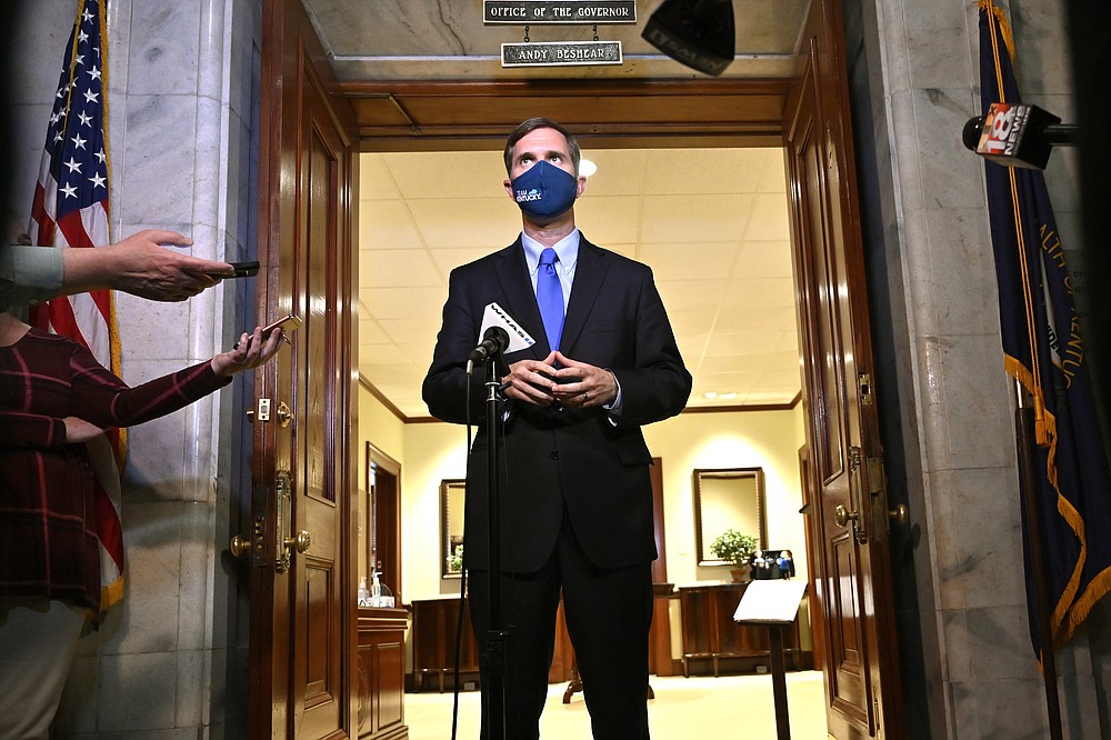 Kentucky Gov. Andy Beshear speaks to reporters following the signing of bills related to the American Rescue Plan Act at the Kentucky State Capitol in Frankfort, Ky., Wednesday, April 7, 2021. (AP Photo/Timothy D. Easley)