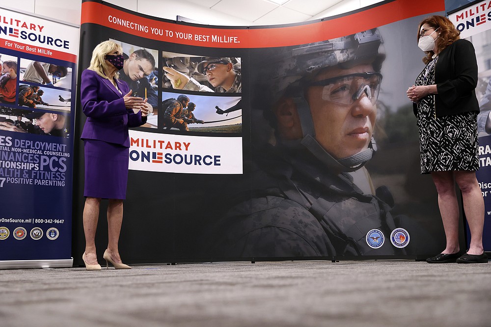 First lady Jill Biden tours Military One Source, an active duty military resource hub/call center for service members, their family and survivors, in Arlington, Va, in Wednesday, April 7, 2021. In announcing the relaunch of Joining Forces, Biden said the initiative will focus on employment and entrepreneurship opportunities for military families, education for the more than 2 million children of enlisted parents and veterans, and the overall health and well-being of these families (Tom Brenner/Pool via AP)