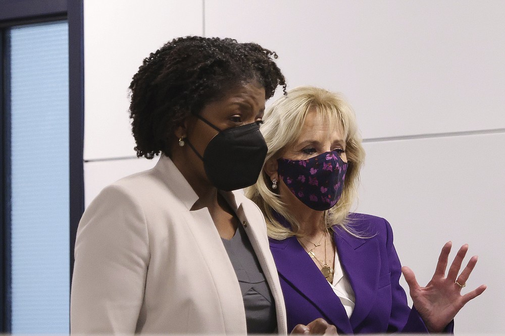 First lady Jill Biden talks with Charlene Austin, wife of Defense Secretary Lloyd Austin, as she tours Military One Source, an active duty military resource hub/call center for service members, their family and survivors, in Arlington, Va, in Wednesday, April 7, 2021. In announcing the relaunch of Joining Forces, Biden said the initiative will focus on employment and entrepreneurship opportunities for military families, education for the more than 2 million children of enlisted parents and veterans, and the overall health and well-being of these families (Tom Brenner/Pool via AP)