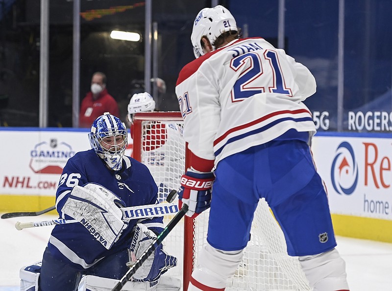 Toronto Maple Leafs goaltender Jack Campbell (36) bats the puck out of the air as Montreal Canadiens forward Eric Staal (21) keeps close during the second period of Wednesday's game in Toronto. - Photo by Nathan Denette/The Canadian Press via The Associated Press