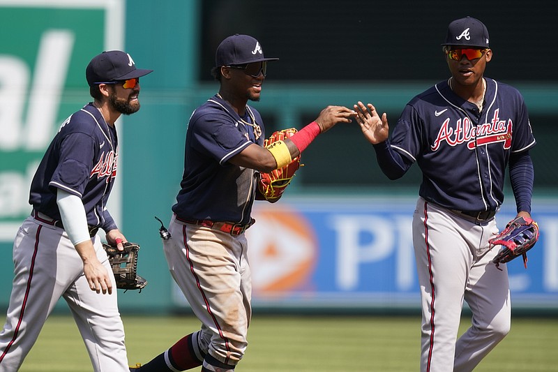 Atlanta Braves outfielders Ender Inciarte, left, Ronald Acuna Jr., and Marcell Ozuna celebrate after the first game of Wednesday's doubleheader at Nationals Park in Washington. The Braves won the first game 7-6. - Photo by Alex Brandon of The Associated Press