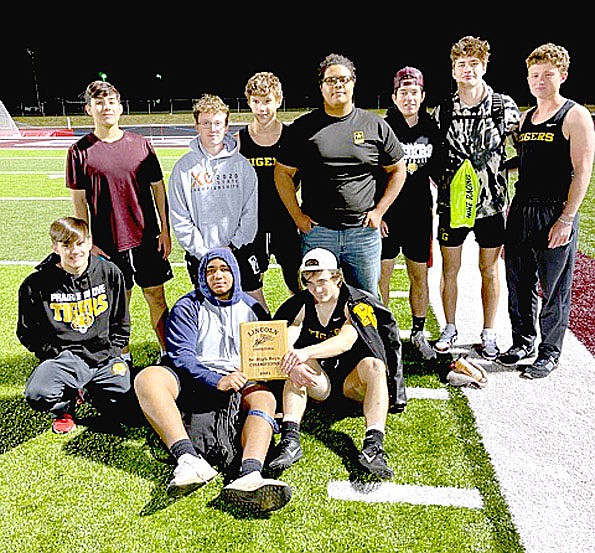 Submitted photo/The Prairie Grove varsity boys track and field team (standing from left): Wesley Key, Zeke McDonald, Wyatt Young,Conner Brunson, Ethan Miller, Landon Semrad, and Garrett Wade along with (sitting from left): Michael Uher, James Moss, and Coner Whetsell, won the team trophy while competing at the Wolf Relays hosted by Lincoln on Thursday, April 1, at Wolfpack Stadium.